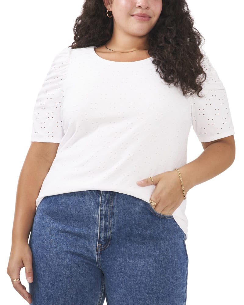 Front of a model wearing a size 1X Anisa Ruffle Sleeve Eyelet Top in ULTRA WHITE by Vince Camuto. | dia_product_style_image_id:261451